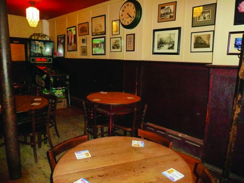 Framed photographs of New London in past decades line the tavern's walls.